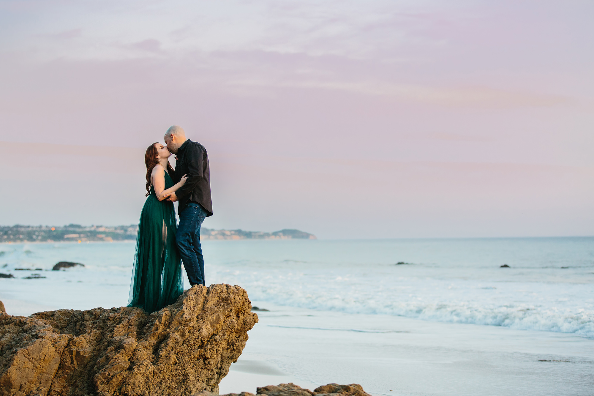el matidor beach in malibu engagement session. couple kissing on rock