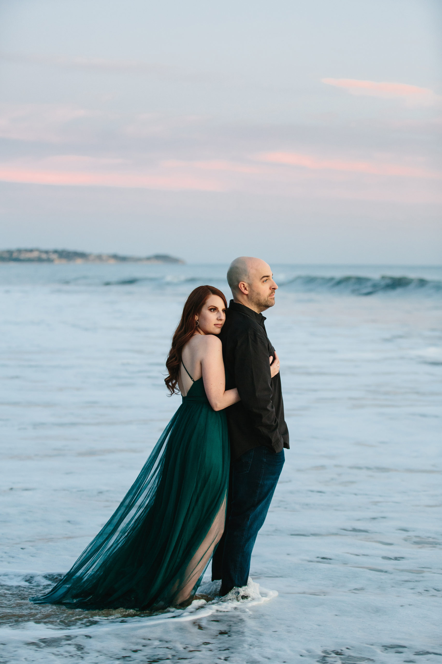 vertical photo of engaged bride and groom being photographed in southern california